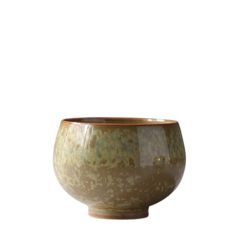A ceramic tea cup with a beige and brown tenmoku (muddy) glaze.