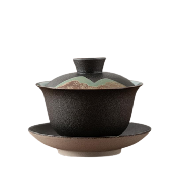 A gray and beige ceramic tea cup with a lid and a handle, featuring a mountain-like design on the side.