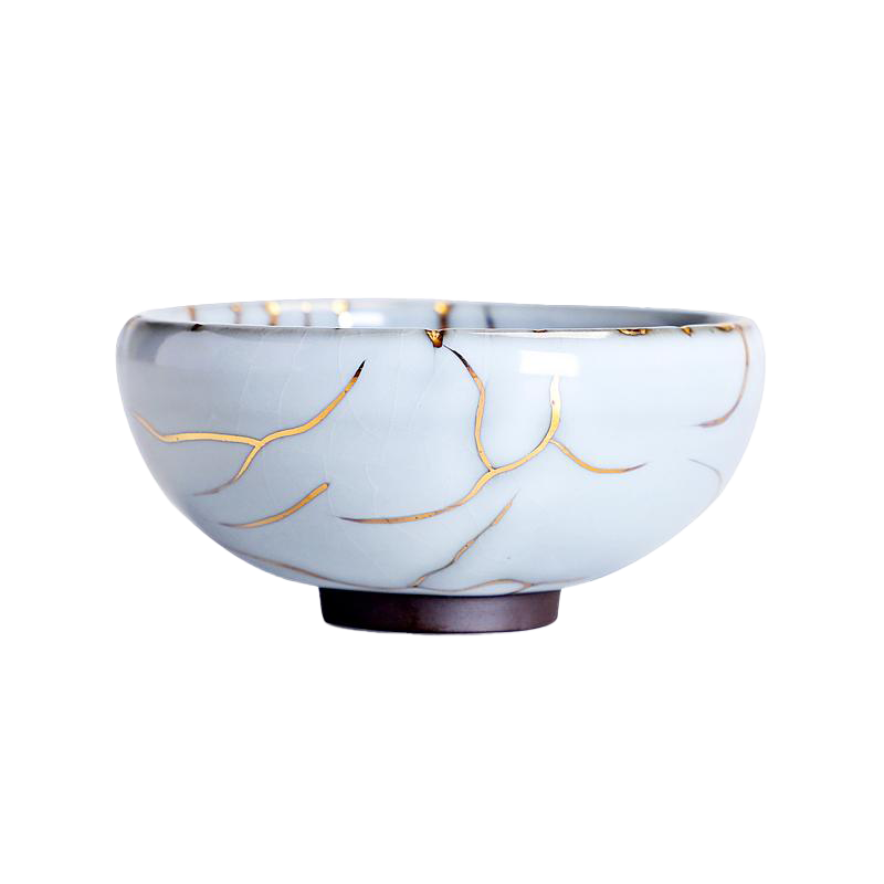 A blue ceramic tea cup with a gold crackle pattern on the side, displayed against a white background.