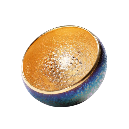 A high-fired ceramic tea cup with a blue and gold color pattern and a central golden circle.