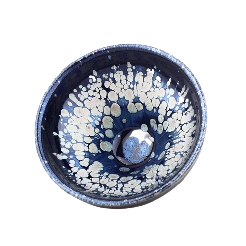 A blue and white tenmoku teapot with a snowflake pattern and a central handle.