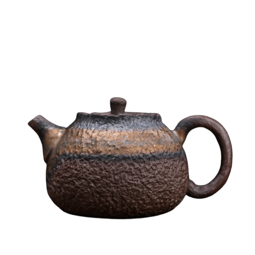 A vintage brown ceramic teapot with a rustic finish and a handle on the side.