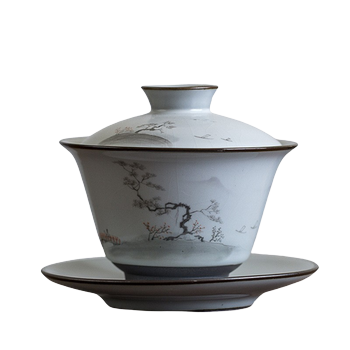 A white and gray teapot with floral and mountainous patterns, sitting on a matching gray base with a handle.