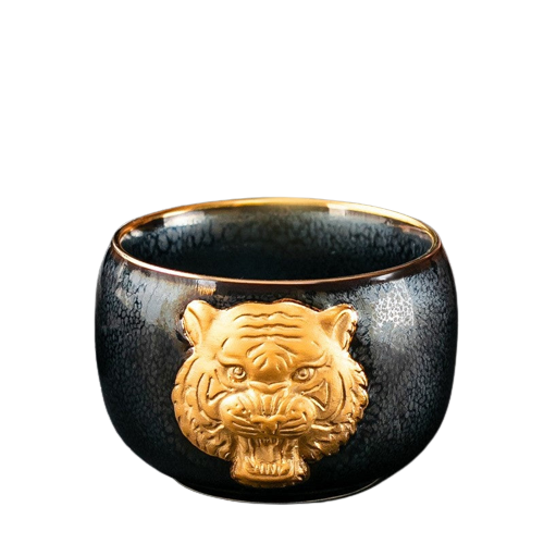 A black ceramic tea cup with a gold tiger symbol on the side.
