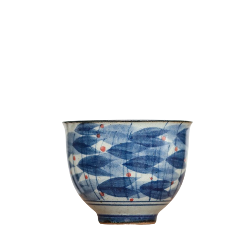 A ceramic tea cup with blue and white colors, featuring a geometric pattern.