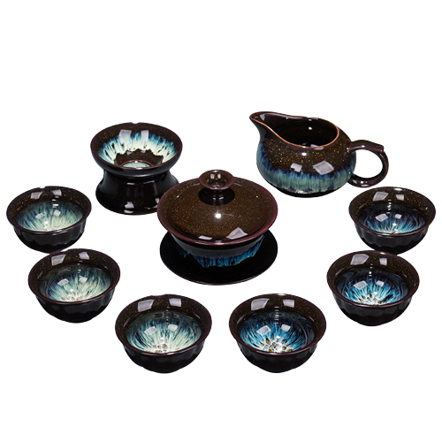 A set of ceramic tea set including six cups, a teapot, and a tea strainer, with a purple and black glaze.