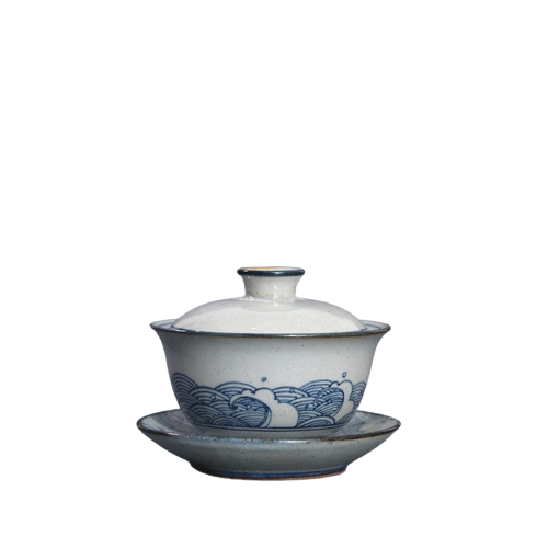 A white and blue ceramic Gai Wan with a floral pattern, featuring a lid and a handle.