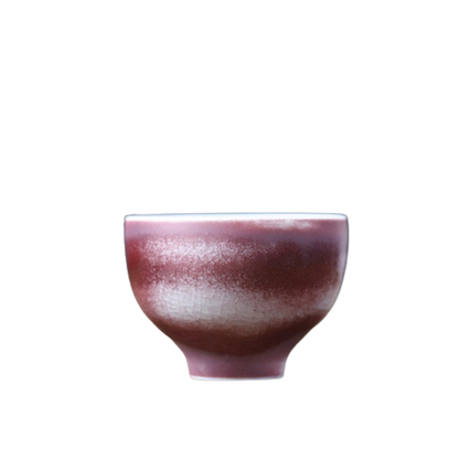 A purple and brown ceramic art tea cup with a textured surface.