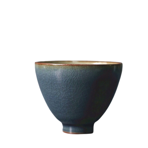 A blue art ceramic tea cup with a rustic finish.