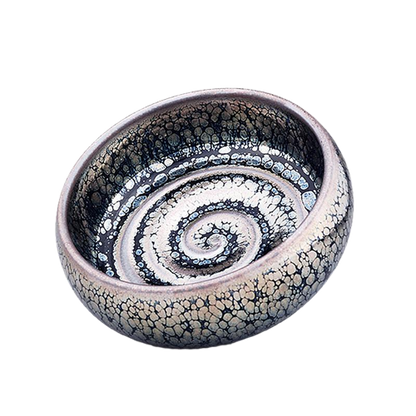 A swirling patterned ceramic tea cup.