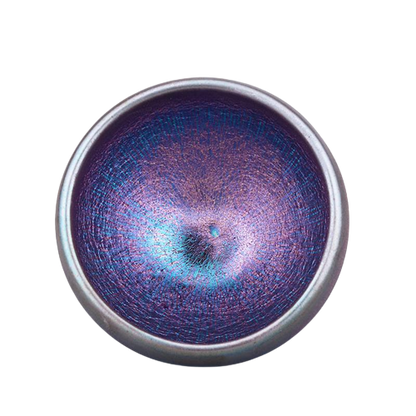 A ceramic tea cup with a gradient of purple to blue color and a textured surface.