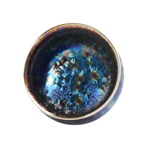 A ceramic tea cup with a blue and black color pattern and a floral design on the side.