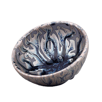 A set of two artistic ceramic tea cups with a swirling blue and gray pattern.