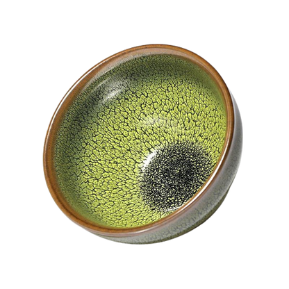A round ceramic tea cup with a green and brown glaze and a black center.